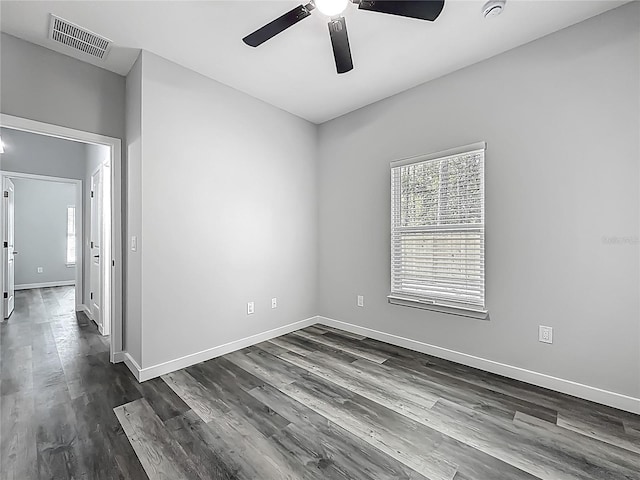 10625 Amos Ave, Hastings, FL 32145 - spare room featuring dark wood finished floors, baseboards, a ceiling fan, and visible vents