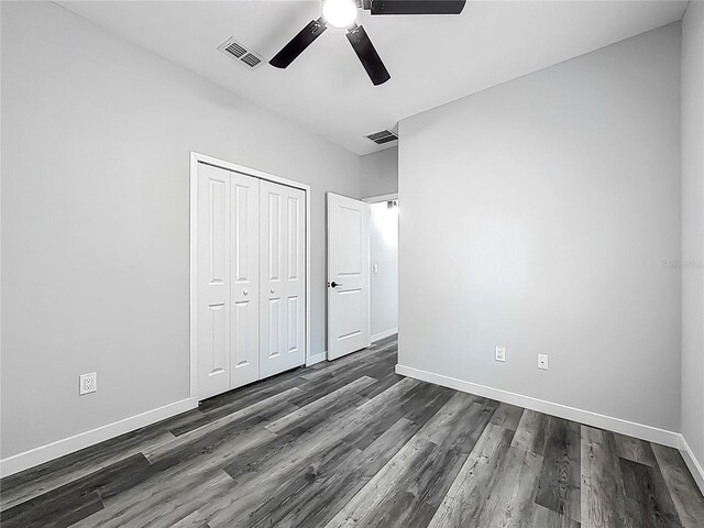 10625 Amos Ave, Hastings, FL 32145 - unfurnished bedroom featuring a closet, baseboards, dark wood finished floors, and visible vents