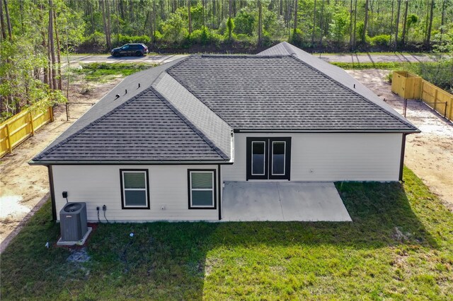 10625 Amos Ave, Hastings, FL 32145 - back of house featuring a yard, central AC unit, fence, and a shingled roof
