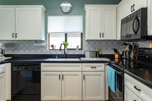 kitchen with a sink, black appliances, white cabinetry, and dark countertops