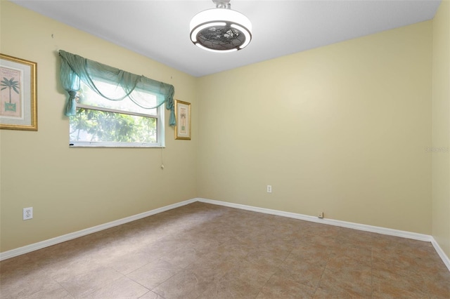 spare room with baseboards