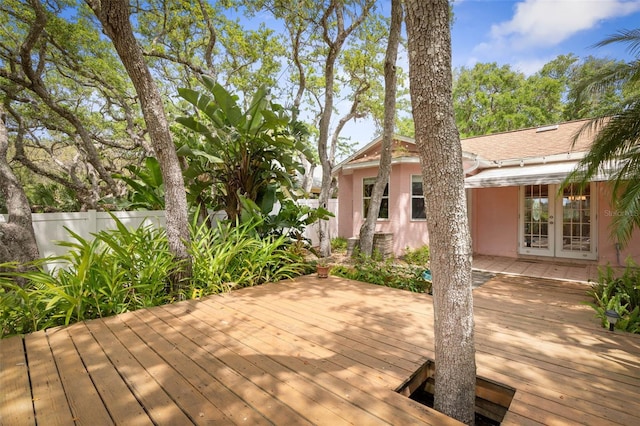wooden deck featuring french doors and fence