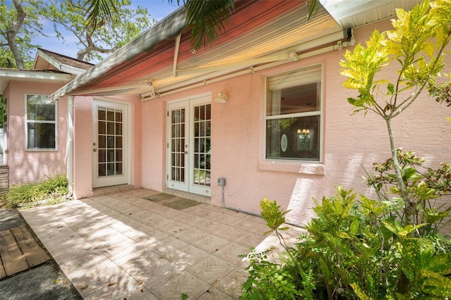 exterior space with a patio, french doors, and stucco siding