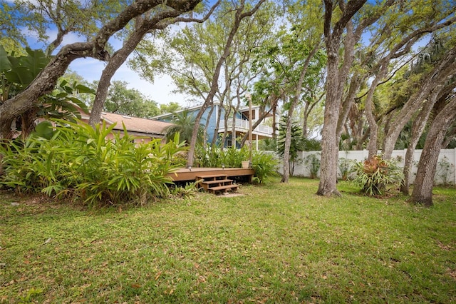 view of yard featuring fence and a wooden deck