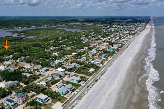 drone / aerial view with a beach view and a water view