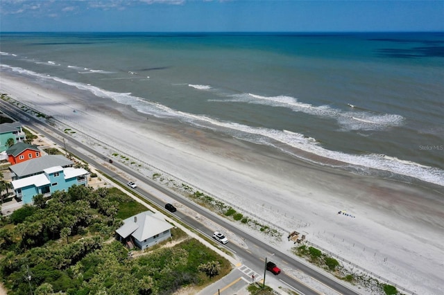 aerial view with a water view and a beach view