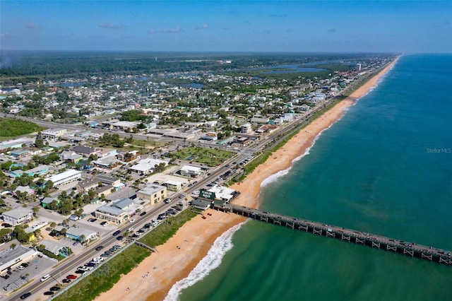 birds eye view of property with a water view and a view of the beach