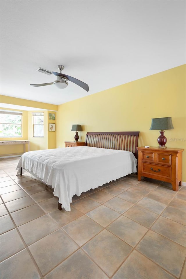 bedroom featuring tile patterned floors, a ceiling fan, and visible vents
