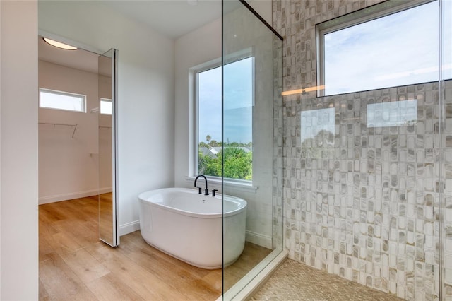 32 Ocean Breeze Cir, Ormond Beach, FL 32176 - full bathroom with a freestanding tub, a tile shower, wood finished floors, and a wealth of natural light