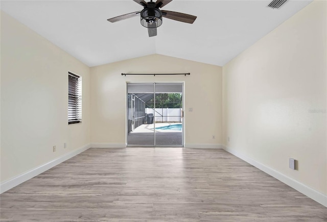 75 Fortune Ln, Palm Coast, FL 32137 - spare room featuring a ceiling fan, wood finished floors, and vaulted ceiling