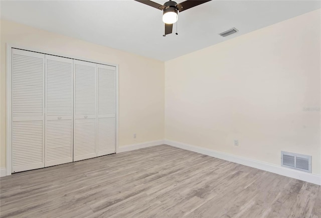 75 Fortune Ln, Palm Coast, FL 32137 - unfurnished bedroom with light wood-style floors, a closet, and a ceiling fan