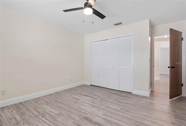 75 Fortune Ln, Palm Coast, FL 32137 - unfurnished bedroom with light wood finished floors, a closet, and a ceiling fan