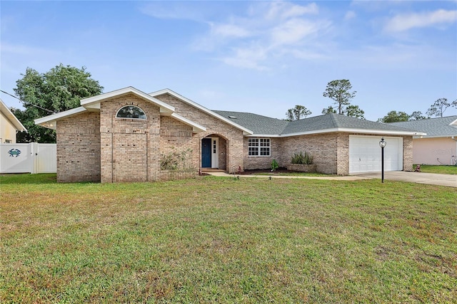 75 Fortune Ln, Palm Coast, FL 32137 - view of front facade with driveway, a garage, brick siding, and a gate