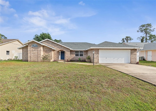 75 Fortune Ln, Palm Coast, FL 32137 - ranch-style home featuring driveway, a garage, a front yard, brick siding, and a shingled roof