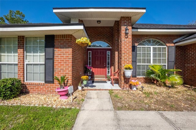 property entrance with brick siding