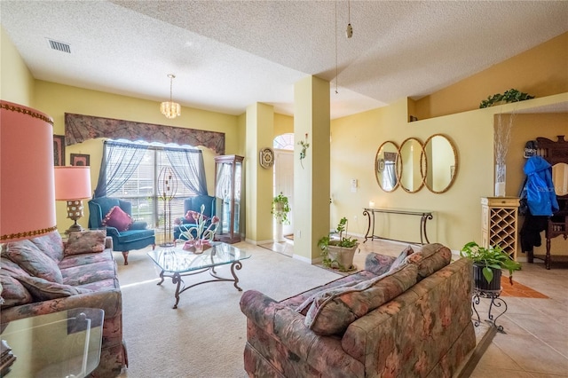 living area with a textured ceiling and visible vents
