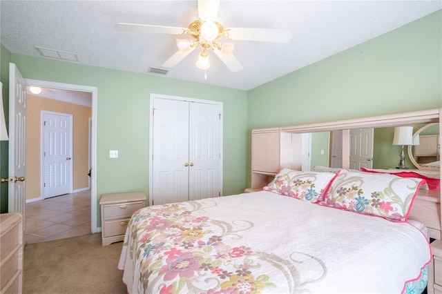 bedroom featuring light carpet, a closet, ceiling fan, and visible vents