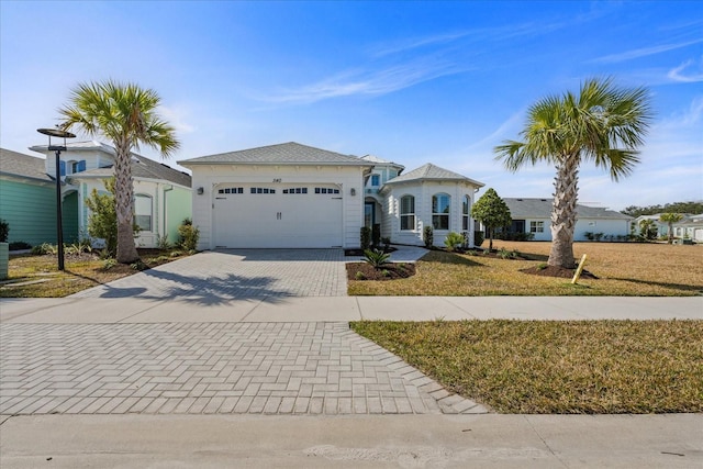 540 Good Life Way, Daytona Beach, FL 32124 - view of front of home with decorative driveway, an attached garage, and a front yard