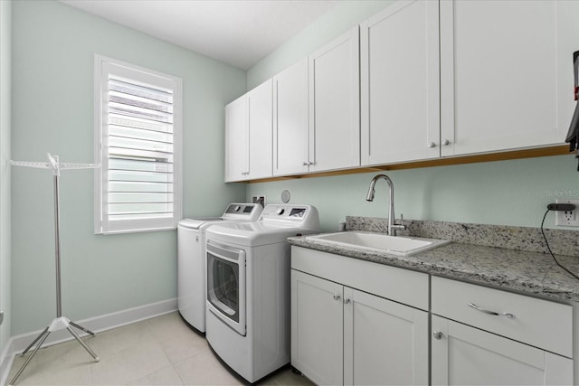 540 Good Life Way, Daytona Beach, FL 32124 - laundry room with washing machine and clothes dryer, cabinet space, baseboards, and light tile patterned flooring