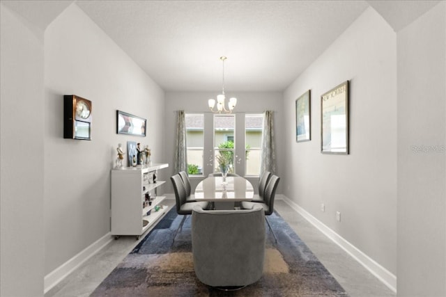 dining area with an inviting chandelier and baseboards