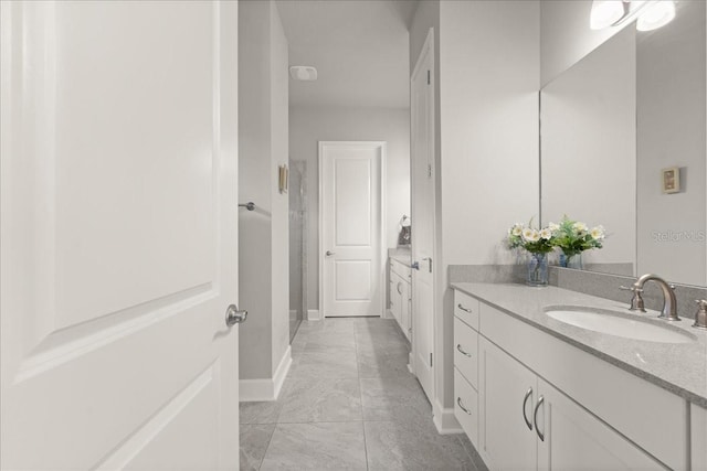 full bathroom featuring vanity and baseboards