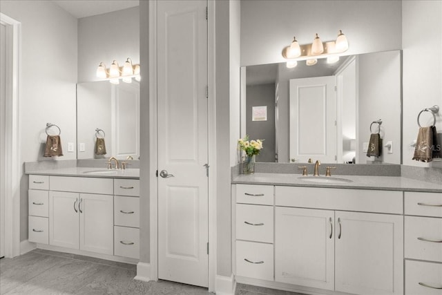 full bath with two vanities and a sink