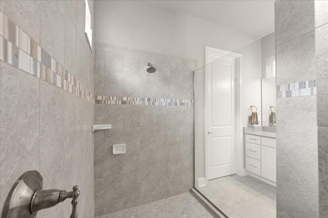 bathroom with vanity, tile patterned flooring, and walk in shower