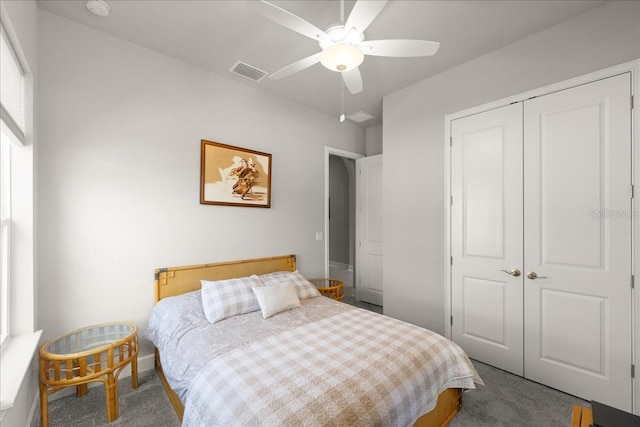 carpeted bedroom featuring visible vents, baseboards, a ceiling fan, and a closet