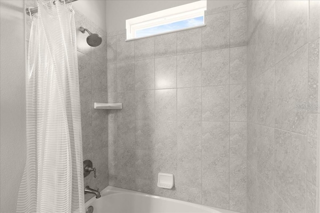 bathroom featuring shower / bathtub combination with curtain