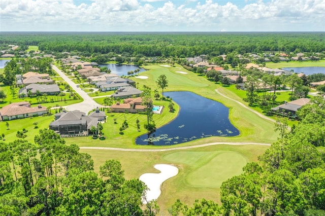 birds eye view of property with a water view, a forest view, and golf course view