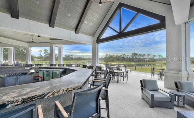 view of patio / terrace with a ceiling fan, a gazebo, and outdoor wet bar