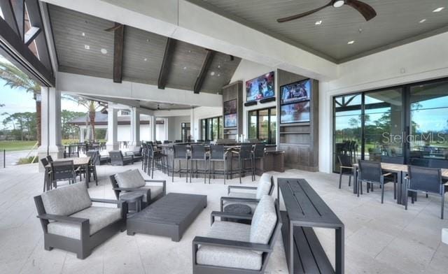 view of patio with an outdoor living space, outdoor dry bar, and a ceiling fan