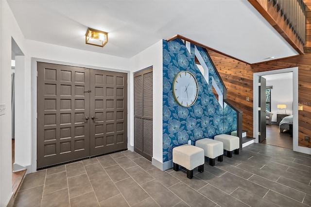 entryway featuring wood walls and baseboards