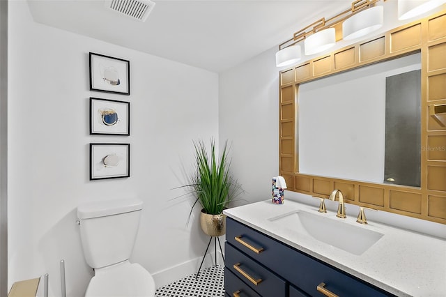 half bathroom with visible vents, toilet, vanity, and baseboards