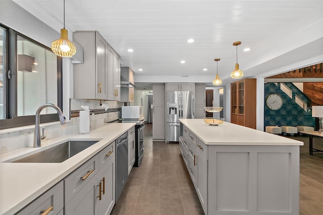 kitchen featuring tasteful backsplash, appliances with stainless steel finishes, light countertops, a sink, and gray cabinetry