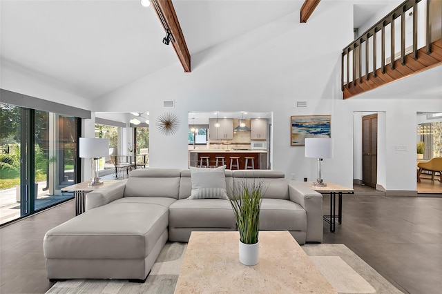 living area featuring beamed ceiling, baseboards, high vaulted ceiling, and visible vents