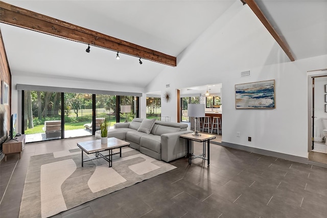 living room with baseboards, rail lighting, visible vents, beamed ceiling, and high vaulted ceiling