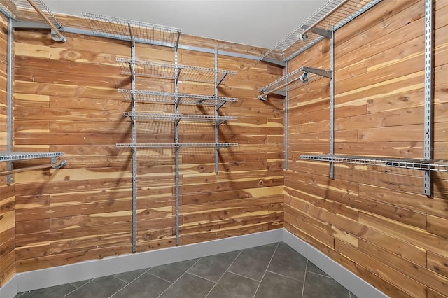 walk in closet featuring dark tile patterned floors