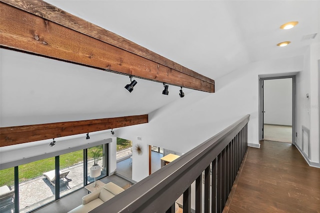 hall featuring lofted ceiling with beams, visible vents, track lighting, and dark wood finished floors
