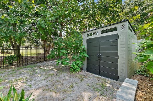 view of shed featuring fence
