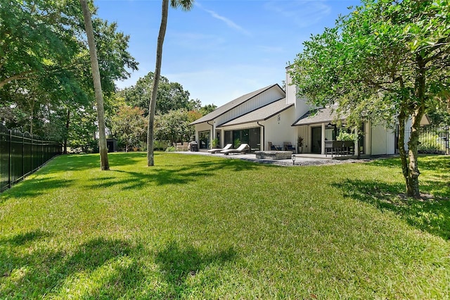 view of yard with a patio and fence