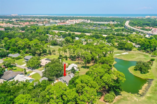 drone / aerial view with a water view and golf course view