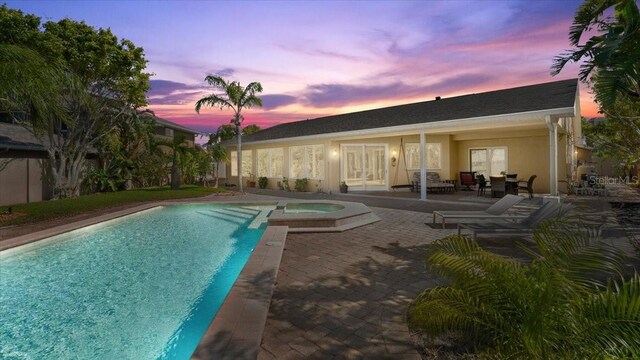 2924 River Point Dr, Daytona Beach, FL 32118 - pool at dusk with a pool with connected hot tub and a patio