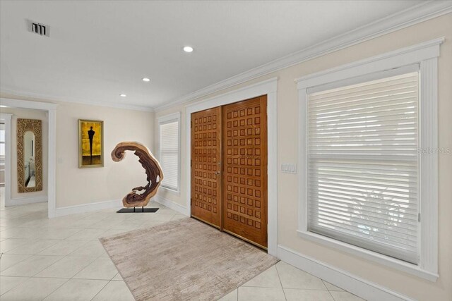 2924 River Point Dr, Daytona Beach, FL 32118 - entryway with ornamental molding, visible vents, baseboards, and light tile patterned floors