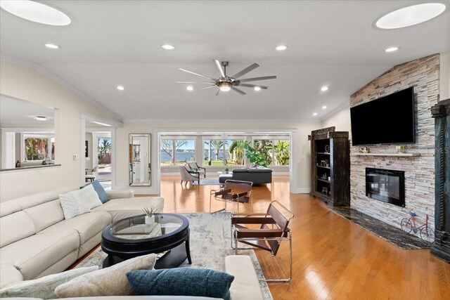 2924 River Point Dr, Daytona Beach, FL 32118 - living room with a ceiling fan, ornamental molding, lofted ceiling, and light wood-style flooring