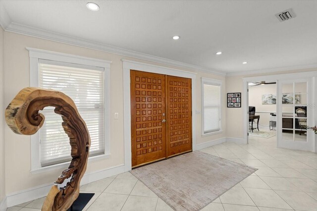 2924 River Point Dr, Daytona Beach, FL 32118 - foyer featuring light tile patterned flooring, baseboards, ornamental molding, and visible vents