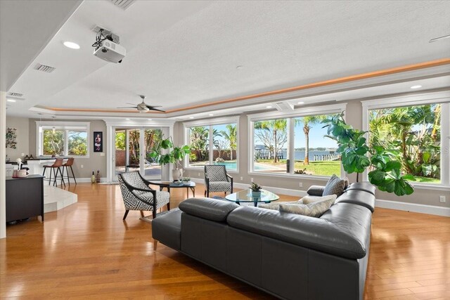 2924 River Point Dr, Daytona Beach, FL 32118 - living room featuring visible vents, light wood-style flooring, a raised ceiling, and a wealth of natural light