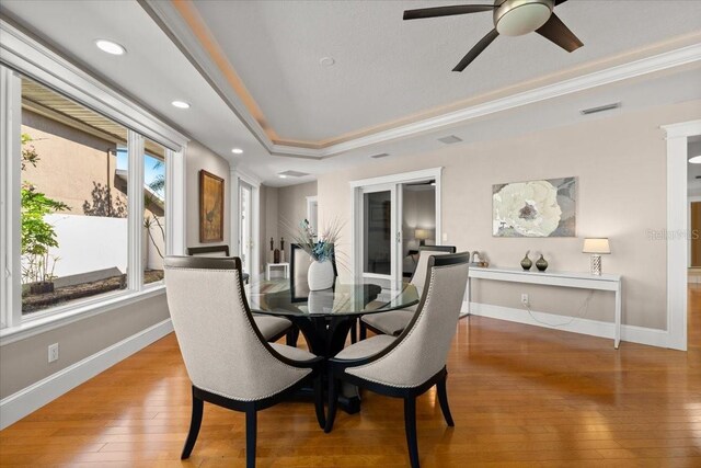 2924 River Point Dr, Daytona Beach, FL 32118 - dining area featuring visible vents, baseboards, a ceiling fan, hardwood / wood-style flooring, and crown molding