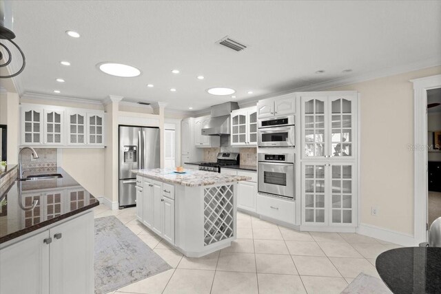 2924 River Point Dr, Daytona Beach, FL 32118 - kitchen with stainless steel appliances, light tile patterned floors, a sink, and wall chimney range hood