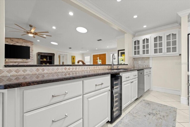 2924 River Point Dr, Daytona Beach, FL 32118 - kitchen with light tile patterned floors, a ceiling fan, ornamental molding, a sink, and beverage cooler